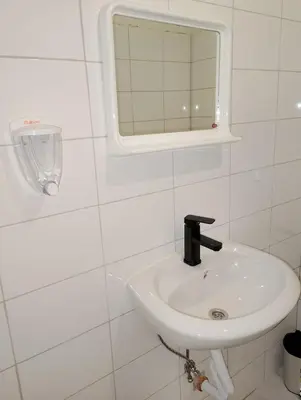 a white bathroom with a sink and a mirror at GuestHouse3 Karma369 in Plovdiv