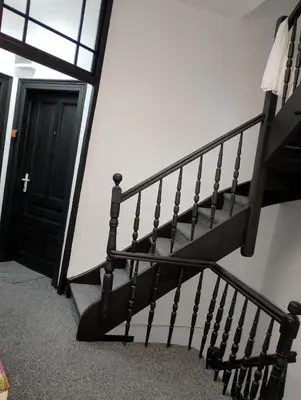 a black spiral staircase with a black door at GuestHouse3 Karma369 in Plovdiv