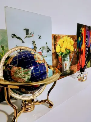 a globe on a stand on a table with flowers at GuestHouse3 Karma369 in Plovdiv
