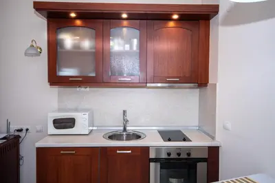 a kitchen with a sink and a microwave at Ametist - Comfort by the Gondola Lift in Bansko