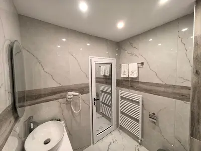a bathroom with a sink and a shower and a toilet at Карина - къща за гости in Ognyanovo