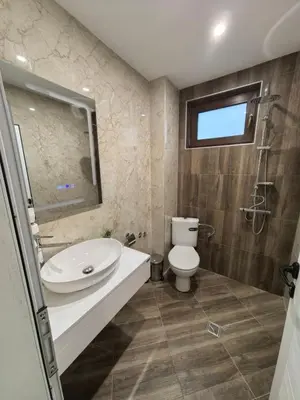 a bathroom with a toilet and a sink and a shower at Карина - къща за гости in Ognyanovo