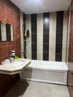 a bathroom with a sink and a bath tub at Lucky Star Bansko Next to the Ski Lift with FREE Parking in Bansko