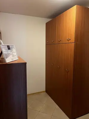 a large wooden cabinet in the corner of a room at Lucky Star Bansko Next to the Ski Lift with FREE Parking in Bansko