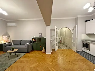 a living room with a couch and a table at Elegant 2BDR Apt for groups and family - Fast Wi-Fi in Sofia