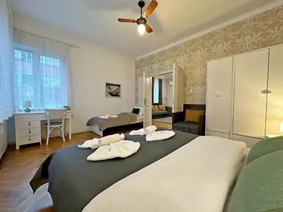 a bedroom with a large bed with towels on it at Elegant 2BDR Apt for groups and family - Fast Wi-Fi in Sofia