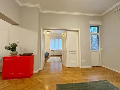 an empty room with a red cabinet and a door at Elegant 2BDR Apt for groups and family - Fast Wi-Fi in Sofia