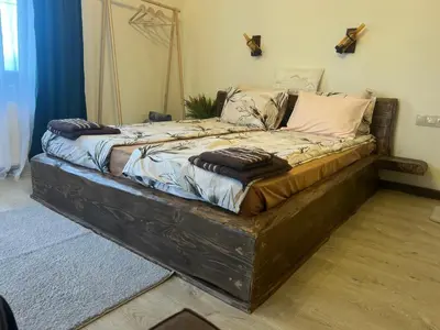 a large bed with pillows on it in a room at Rilski Chardak in Sapareva Banya