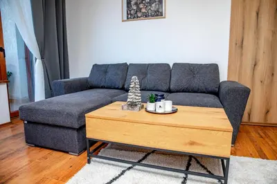 a living room with a couch and a coffee table at Pirin SkiLift Apartment - Cozy & Modern App in Bansko, 100 m to the Gondola in Bansko