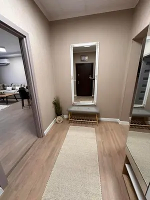 a living room with a hallway with a door and a table at Apart-Hotel Crow Bansko 3 in Bansko