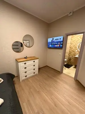 a bedroom with a dresser and a tv on the wall at Apart-Hotel Crow Bansko 3 in Bansko