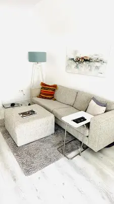 a living room with a couch and a table at Bulgaria Mall Flat in Sofia