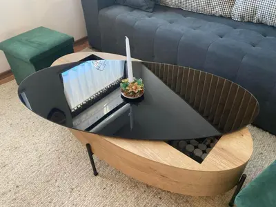 a coffee table with a tv in a living room at Студио за гости Петрови in Bansko