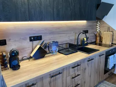 a kitchen with a counter with a sink and a counter at Студио за гости Петрови in Bansko