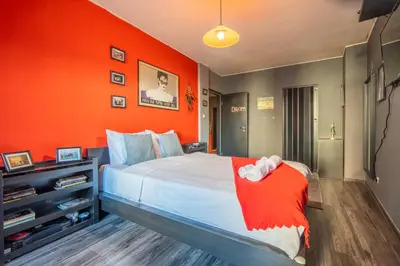 a bedroom with a bed with an orange wall at Free parking 1BR Tokuda Lozenets in Sofia