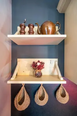 a shelf with a tea pot and a vase on it at Free parking 1BR Tokuda Lozenets in Sofia