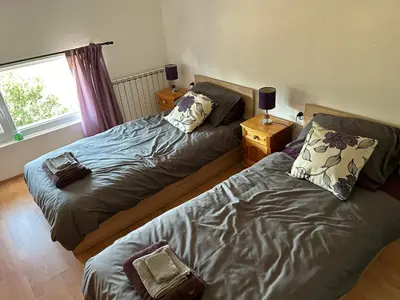 a bedroom with two beds and a window at Relyovo Lodge in Relyovo