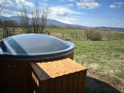 a hot tub sitting on top of a wooden table at Relyovo Lodge in Relyovo