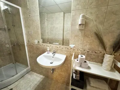 a bathroom with a sink and a shower at Alpine Glow - Panoramic View near Gondola in Bansko