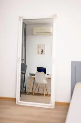 an open door into a room with a desk and a chair at 2-Bedroom Apartment near Tokuda Hospital & Paradise Mall in Sofia
