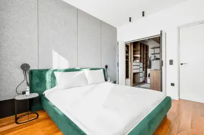 a bedroom with a large white bed with a green headboard at View, Location, High End Interior, Lift, AC in Sofia