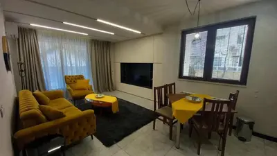 a living room with a couch and a dining room at ATM apart Lagera in Sofia