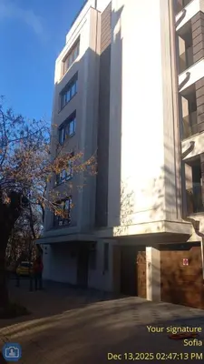 a tall white building with people standing in front of it at ATM apart Lagera in Sofia