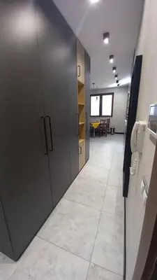 an office hallway with gray lockers and a table at ATM apart Lagera in Sofia