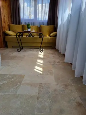 a yellow couch in a room with a window at Old House - Стара Къща in Koprivshtitsa