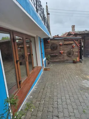 a building with a wooden door and a patio at Old House - Стара Къща in Koprivshtitsa