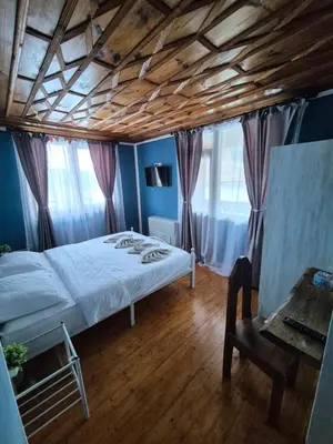 a bedroom with a bed and a wooden ceiling at Old House - Стара Къща in Koprivshtitsa
