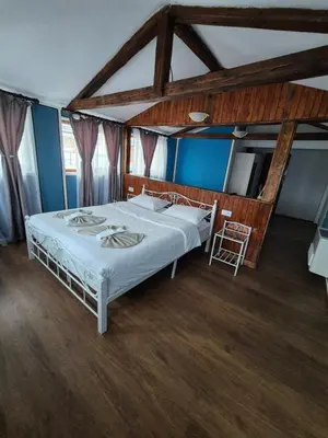 a bedroom with a large bed in a room with blue walls at Old House - Стара Къща in Koprivshtitsa