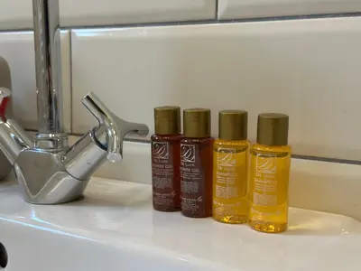 three bottles of oil sitting on top of a sink at Romantic 1BDR apt near Eagle bridge - Fast Wi-Fi in Sofia