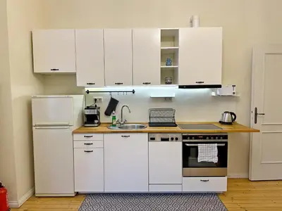 a kitchen with white cabinets and a sink at Romantic 1BDR apt near Eagle bridge - Fast Wi-Fi in Sofia