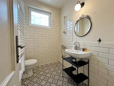 a white bathroom with a sink and a mirror at Romantic 1BDR apt near Eagle bridge - Fast Wi-Fi in Sofia
