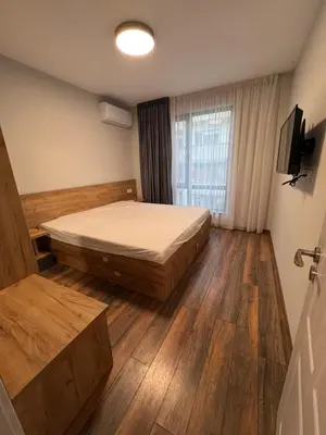 a bedroom with a bed and a television in it at MedHill Stay - Medical University Area in Plovdiv