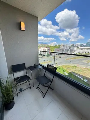 a balcony with two chairs and a table and a large window at Wings Apartment 1 Bedroom Luxury-free parking in Sofia