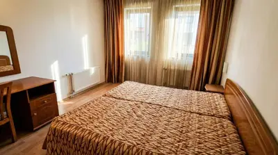 a bedroom with a bed and a dresser and a mirror at Penthouse Duplex Large 2 Bedroom MP1 in Bansko