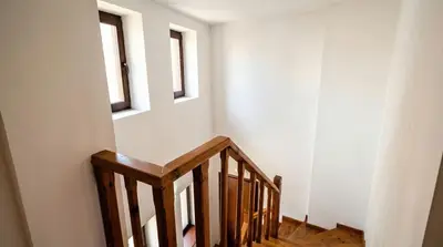 a wooden staircase with two windows in a room at Penthouse Duplex Large 2 Bedroom MP1 in Bansko