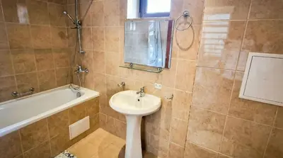 a bathroom with a sink and a bath tub at Penthouse Duplex Large 2 Bedroom MP1 in Bansko