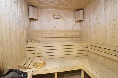 a wooden sauna with a bench in it at Апартамент Orpheus Forest in Pamporovo