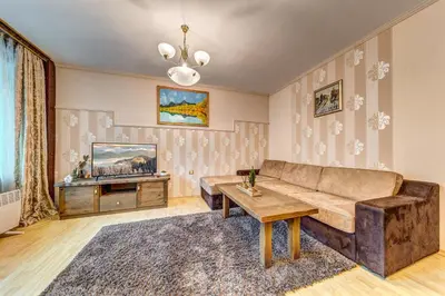 a living room with a couch and a table at Апартамент Orpheus Forest in Pamporovo