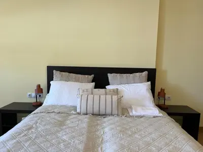 a bedroom with a bed with white sheets and pillows at Rilets Studio in Borovets