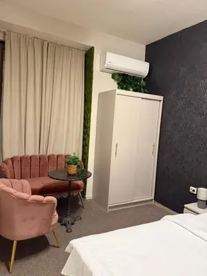 a hotel room with a bed and a table and chairs at Top Center Apartment Sofia in Sofia