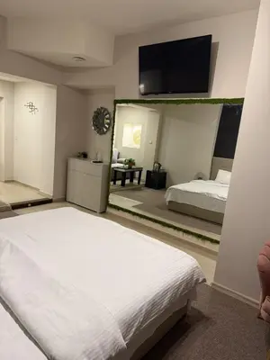 a bedroom with a bed and a large mirror at Top Center Apartment Sofia in Sofia