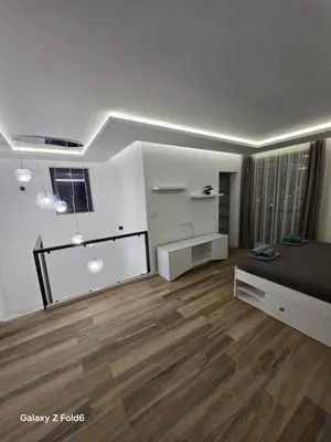 a bedroom with a bed and a wooden floor at Diljanka 4 in Pernik