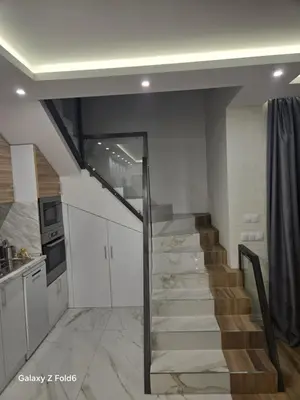 a stairway in a kitchen with a staircase in a house at Diljanka 4 in Pernik