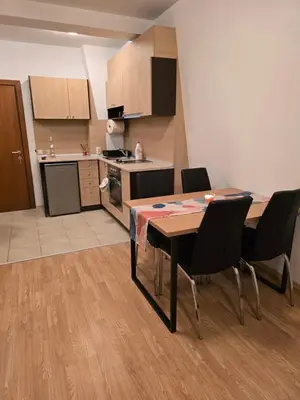a kitchen and dining room with a table and chairs at AspenValley Aprtment in Razlog