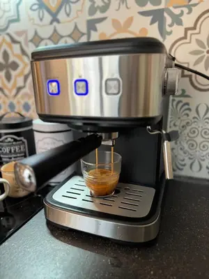 a coffee maker on a counter with a cup of coffee at Top Centre Plovdiv Apartment for 4 Guests & Parking in Plovdiv