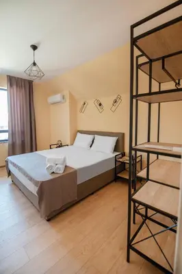 a bedroom with a large bed and a ladder at Apartments by the river 2 in Plovdiv